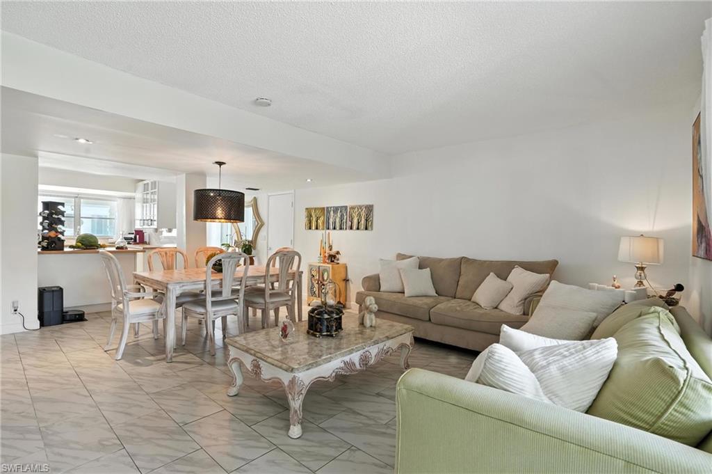 14 Watercolor Way, Unit 14 Naples, FL 34113 - Photo 3 of 37 a living room with furniture white walls and kitchen view