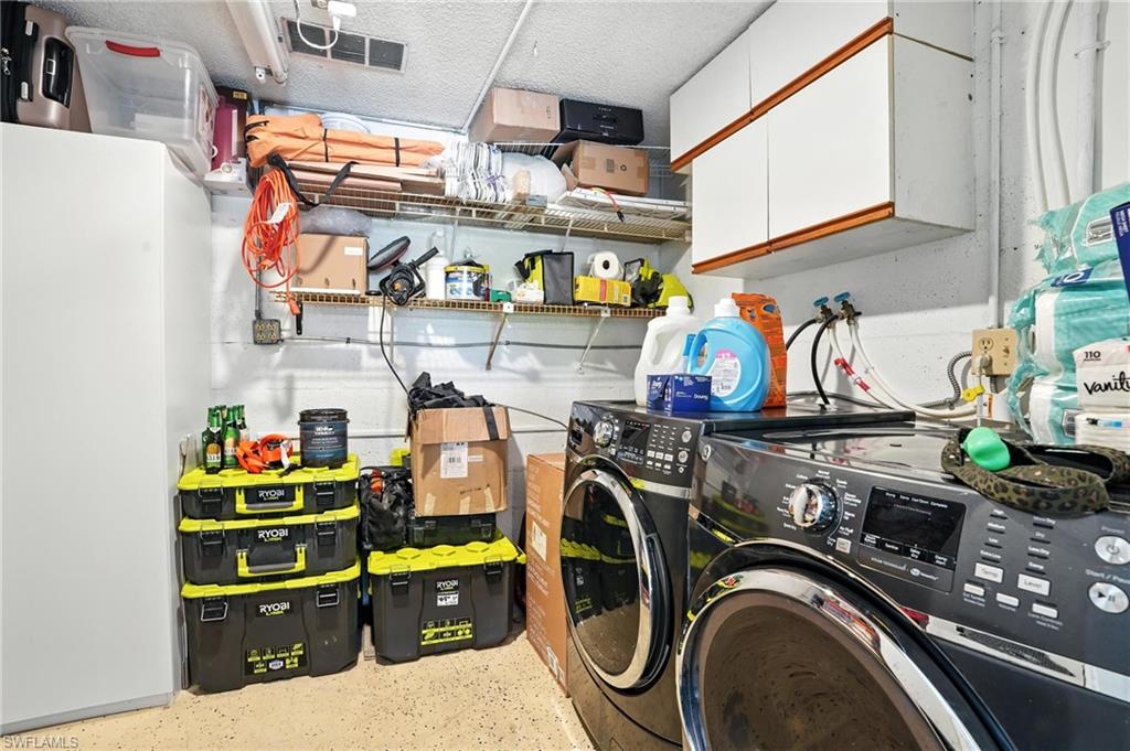 14 Watercolor Way, Unit 14 Naples, FL 34113 - Photo 33 of 37 a utility room with fridge dryer and washer