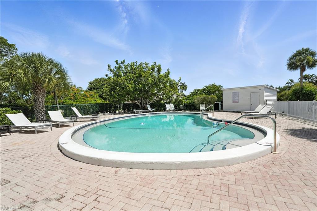 14 Watercolor Way, Unit 14 Naples, FL 34113 - Photo 35 of 37 a view of a swimming pool with a yard