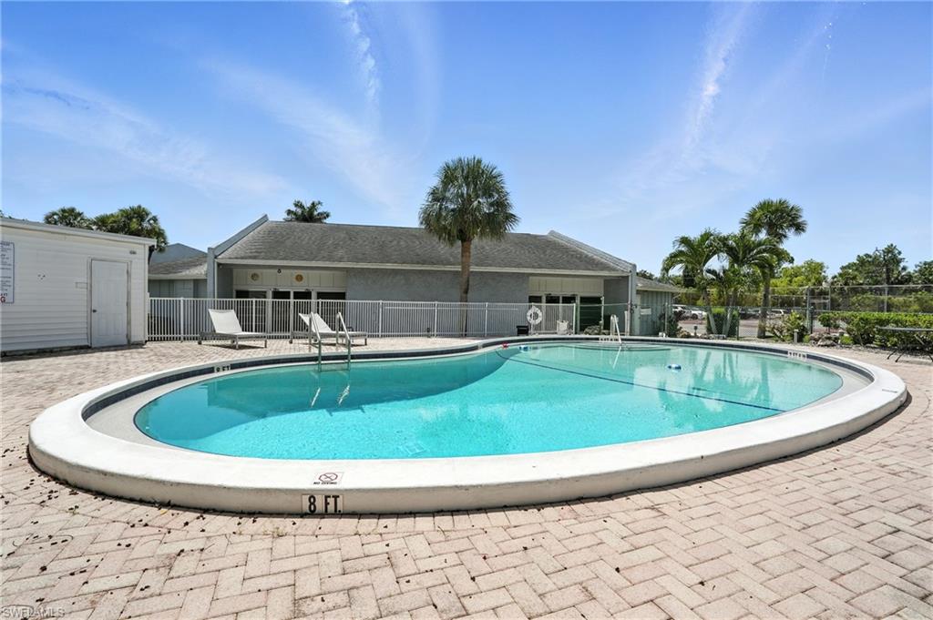 14 Watercolor Way, Unit 14 Naples, FL 34113 - Photo 36 of 37 a view of a swimming pool with a yard in the background