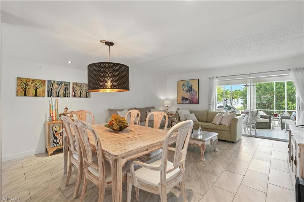 14 Watercolor Way, Unit 14 Naples, FL 34113 - Photo 4 of 37 a dining room with furniture and chandelier