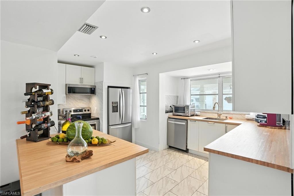 14 Watercolor Way, Unit 14 Naples, FL 34113 - Photo 8 of 37 a kitchen with a sink appliances and cabinets