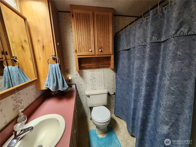 a bathroom with a toilet and a tub