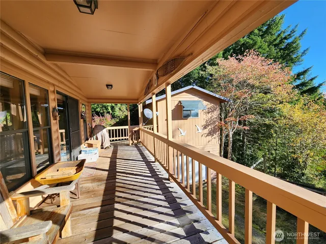 a view of balcony with wooden floor and seating space