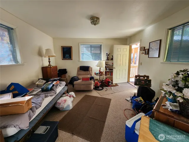 a living room with furniture fireplace and a window