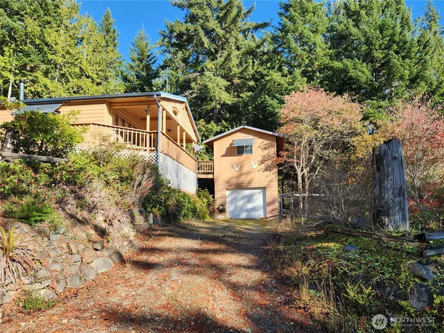 a view of a large white house with a yard