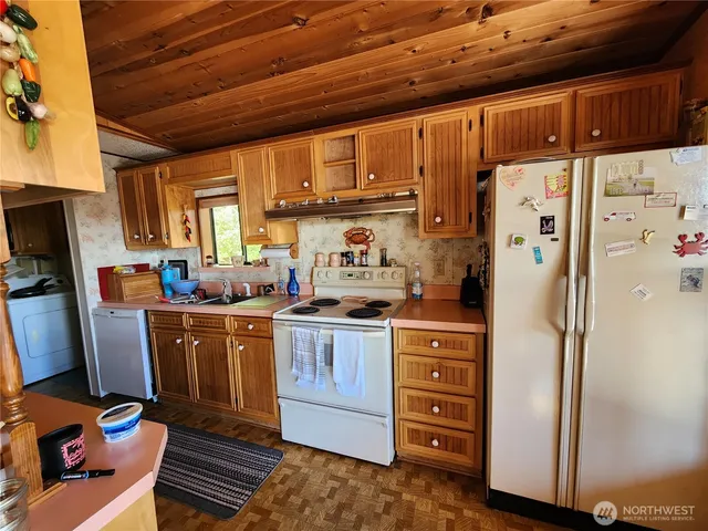 a kitchen with stainless steel appliances granite countertop a refrigerator and a stove