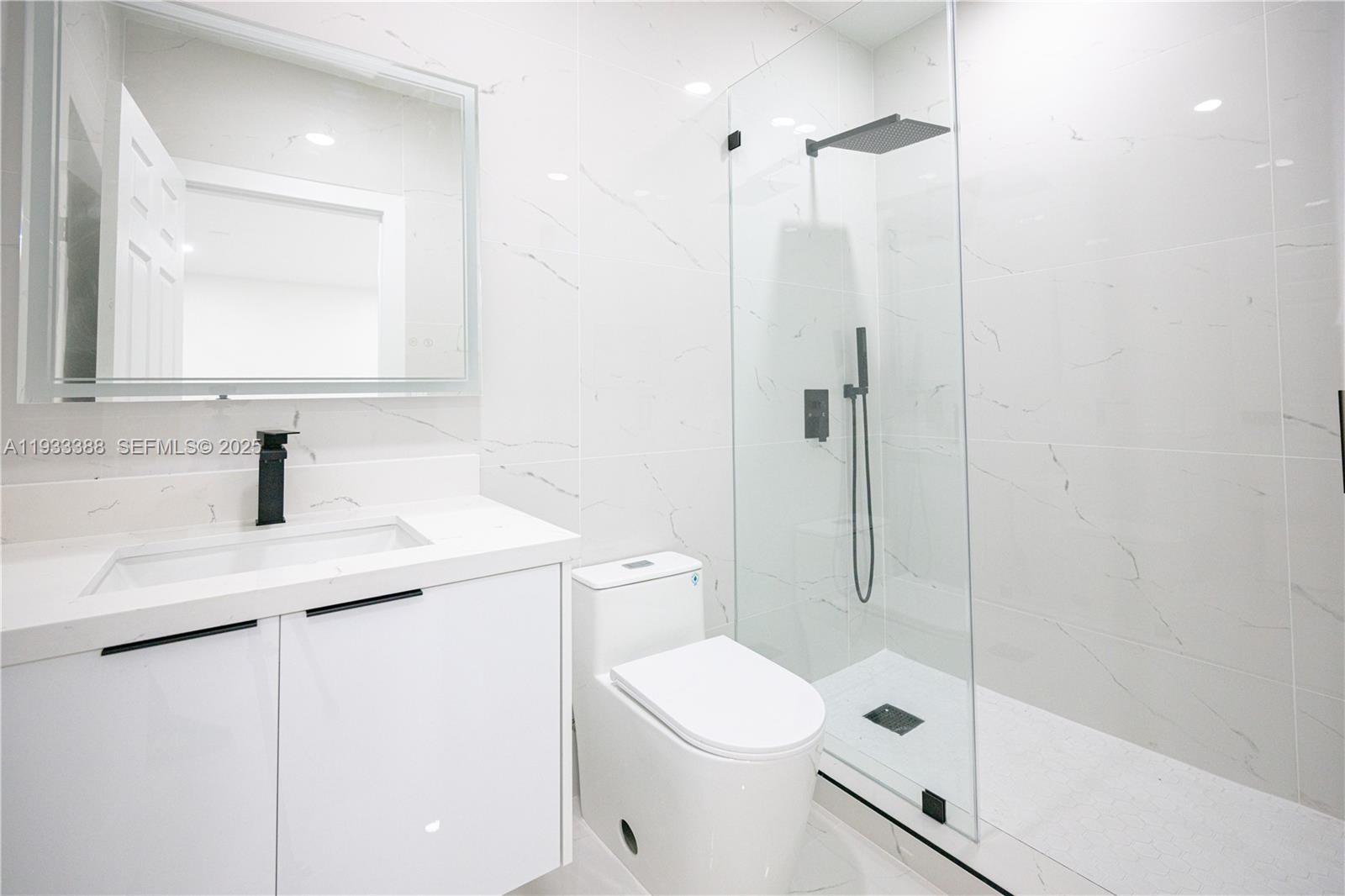 15486 Southwest 23rd Lane Miami, FL 33185 - Photo 23 of 24 a bathroom with a granite countertop sink a toilet and shower