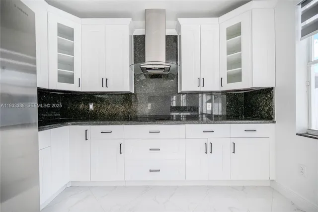 a view of white cabinets and sink