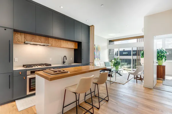 a kitchen with stainless steel appliances a stove a sink and cabinets