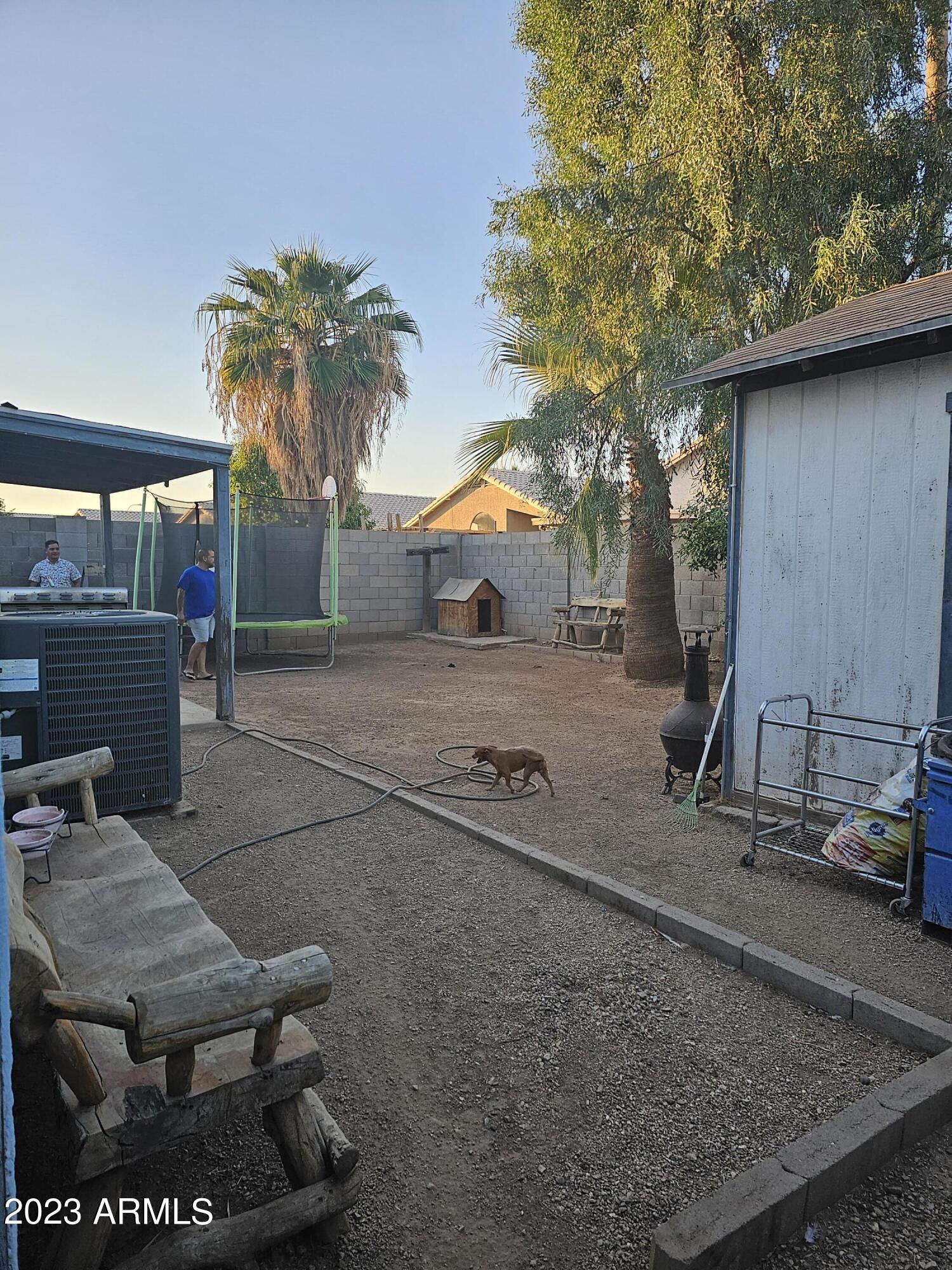 8738 West Granada Road Phoenix, AZ 85037 - Photo 13 of 13 a backyard of a house with barbeque oven table and chairs