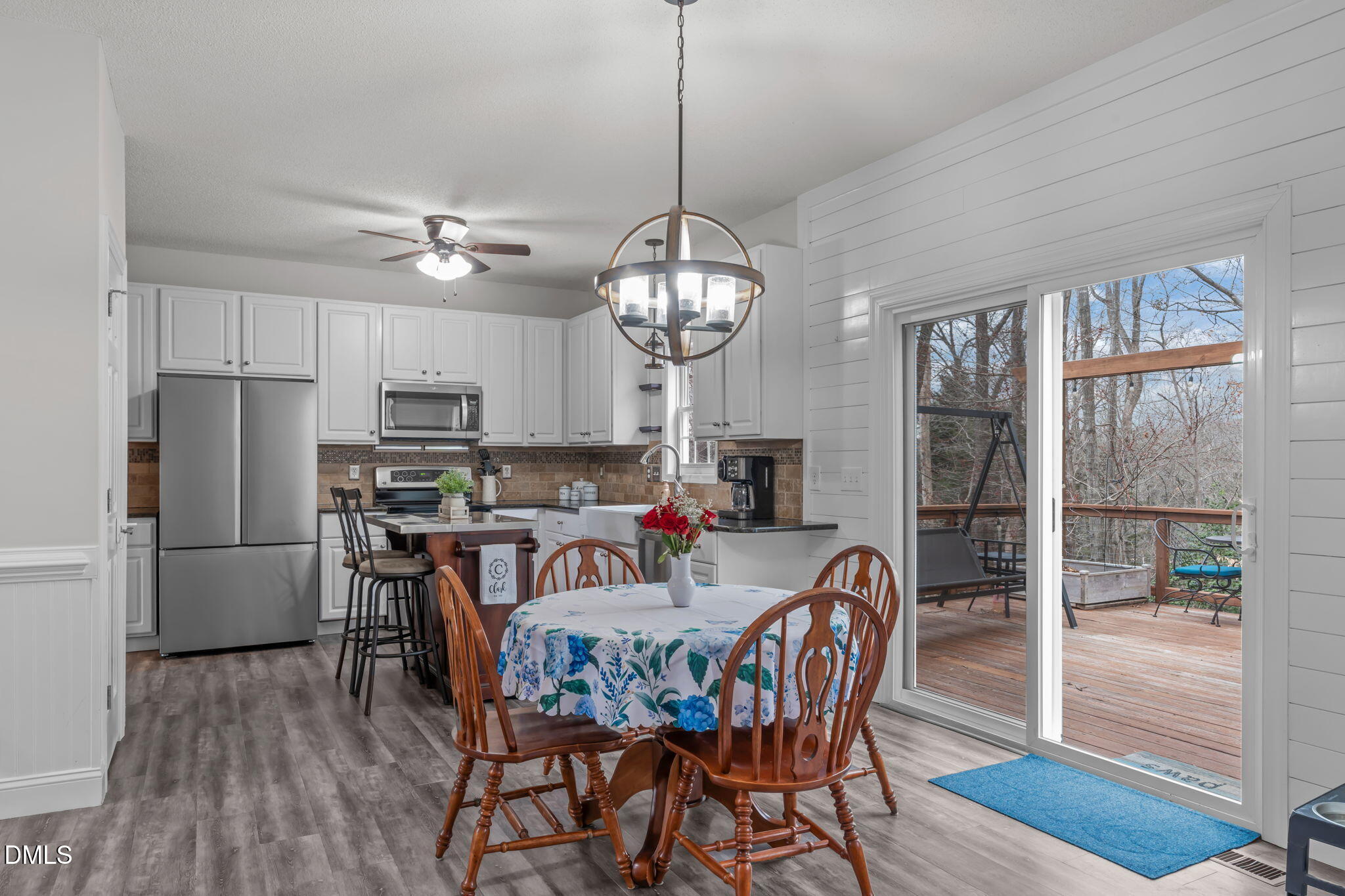 2501 Springfield Park Drive Raleigh, NC 27614 - Photo 11 of 44 a view of a dining room with furniture large window a chandelier and wooden floor