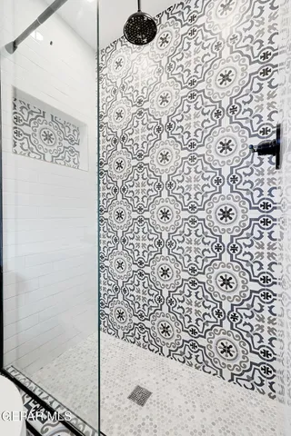 a bathroom with a shower and a sink