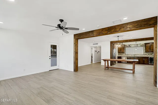 a view of room with wooden floor and furniture
