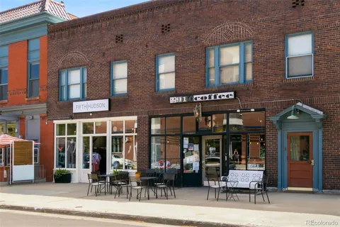 a view of a cafe with a table and chairs and floor to ceiling window