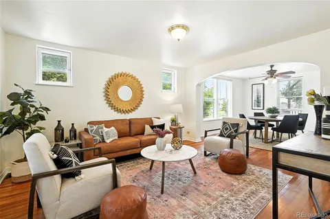 a living room with furniture and a chandelier