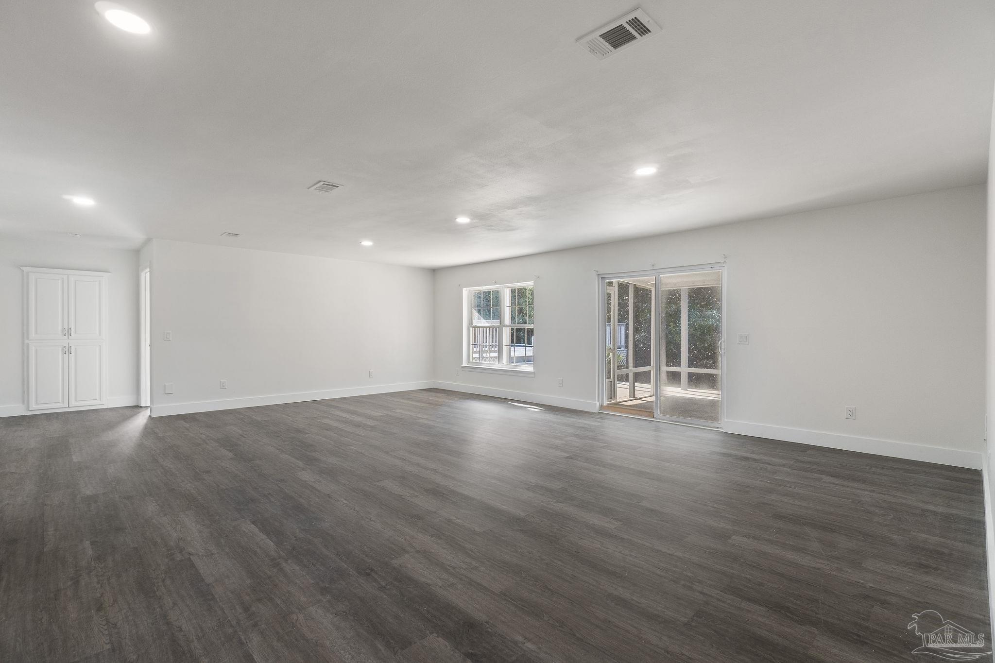 800 Shadow Ridge Drive Pensacola, FL 32514 - Photo 38 of 66 a view of an empty room with wooden floor and a window