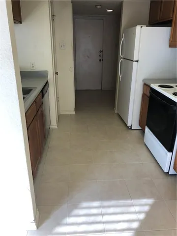 a view of storage and utility room with refrigerator washer and dryer