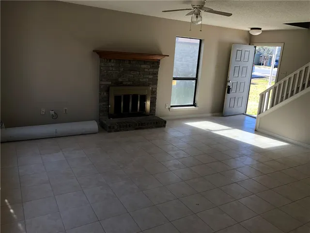 a view of empty room with a fireplace