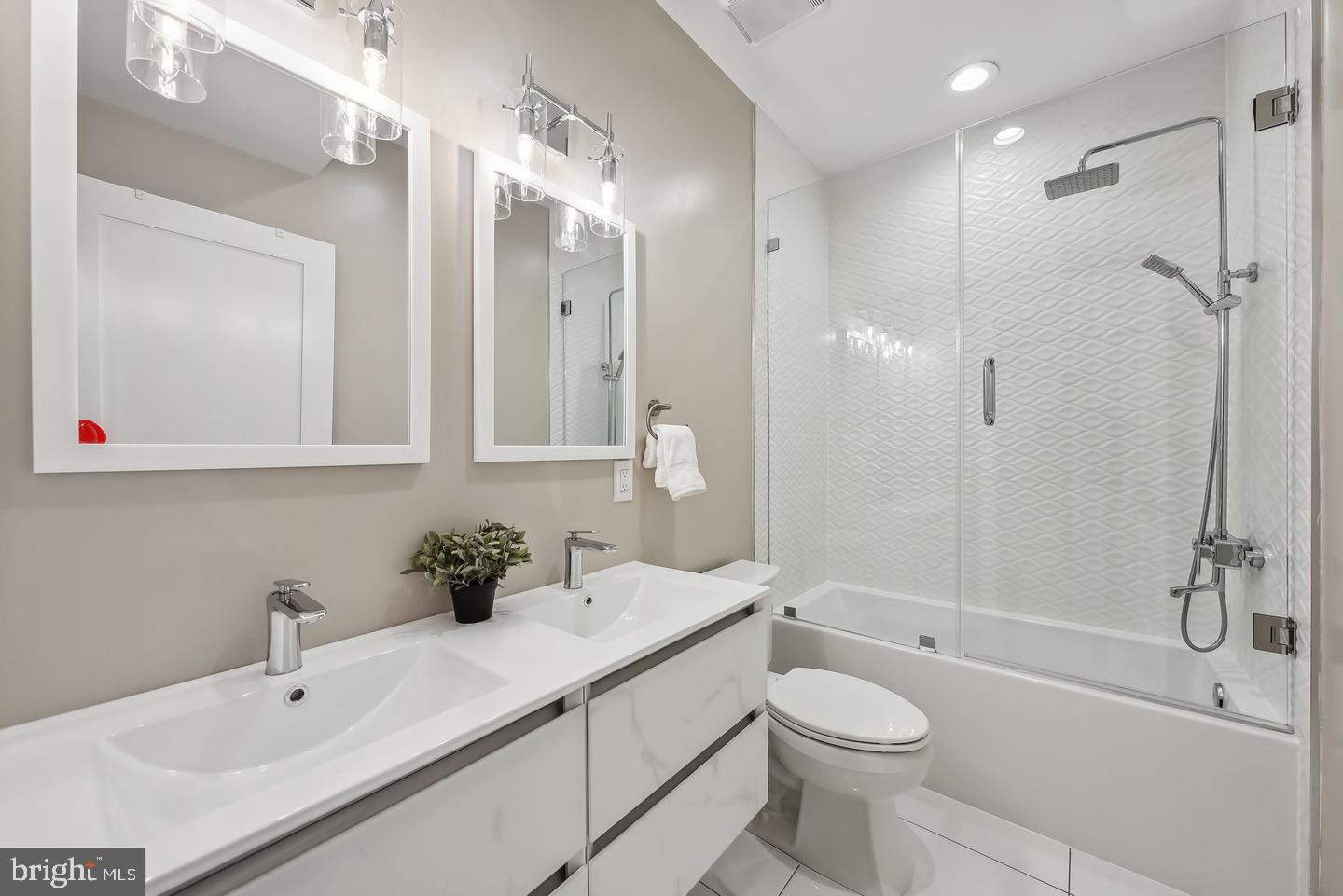 1213 Holbrook Street Northeast, Unit 1 Washington, DC 20002 - Photo 14 of 26 a bathroom with a sink a toilet and shower