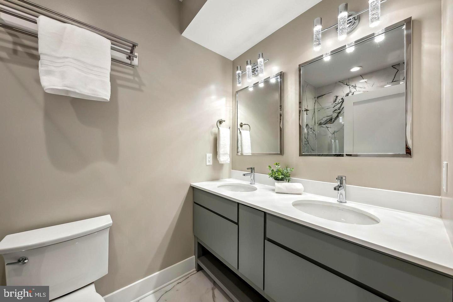 1213 Holbrook Street Northeast, Unit 1 Washington, DC 20002 - Photo 18 of 26 a bathroom with a double vanity sink and mirror
