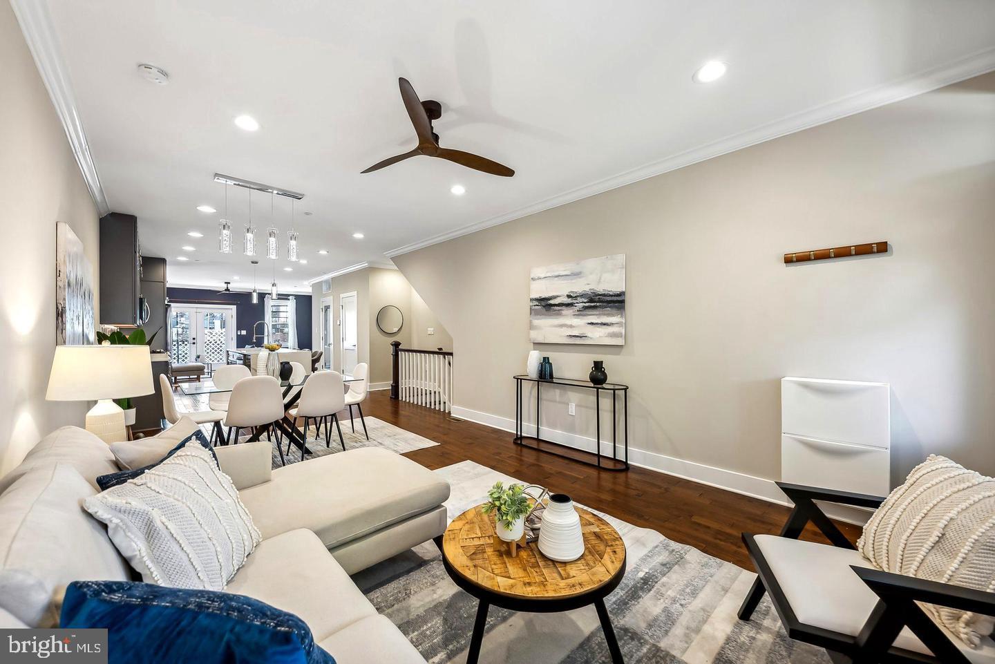 1213 Holbrook Street Northeast, Unit 1 Washington, DC 20002 - Photo 4 of 26 a living room with furniture kitchen view and a chandelier