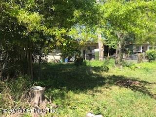 5350 Batley Road Jacksonville, FL 32210 - Photo 4 of 5 a backyard of a house with lots of green space and fountain