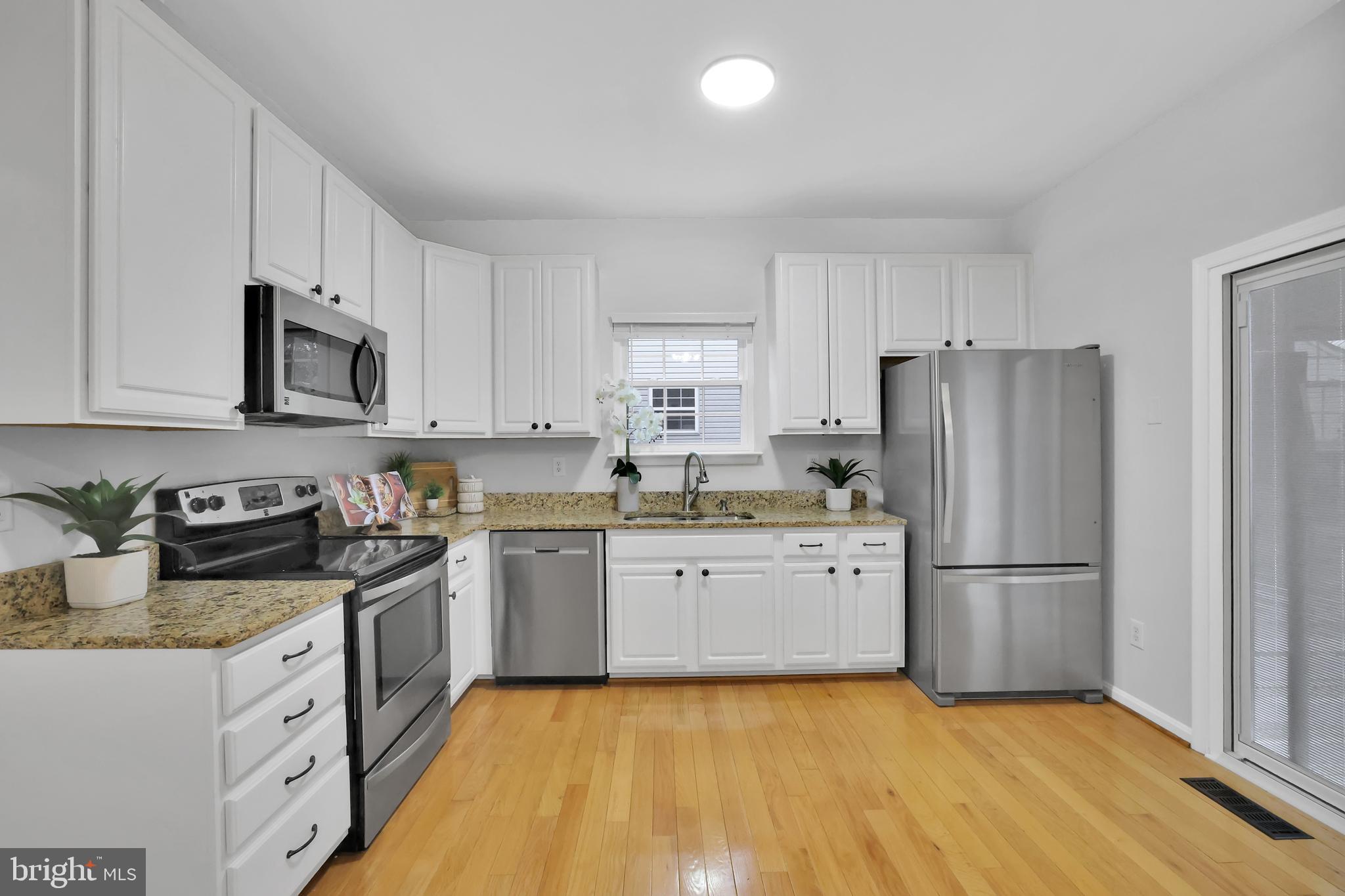 126 Myrtle Avenue Severn, MD 21144 - Photo 4 of 52 a kitchen with granite countertop stainless steel appliances a refrigerator sink and microwave