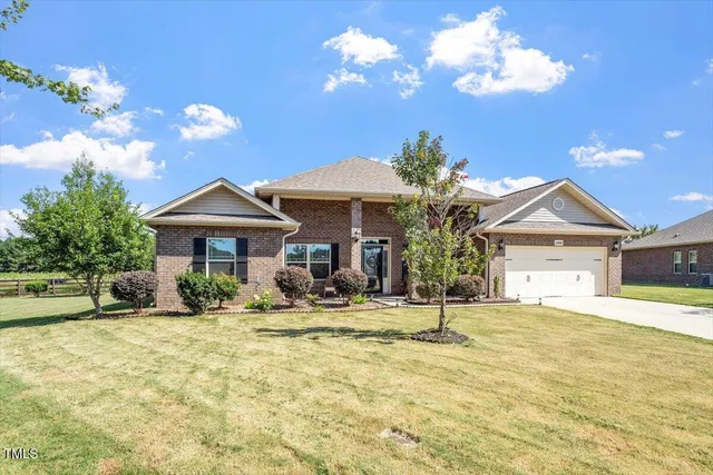 a view of house with yard