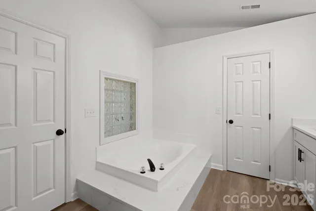 a bathroom with a tub and shower