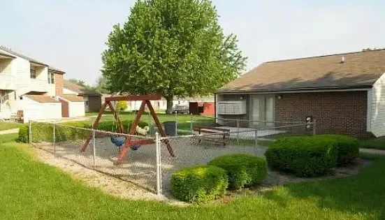 a view of a house with backyard porch and sitting area