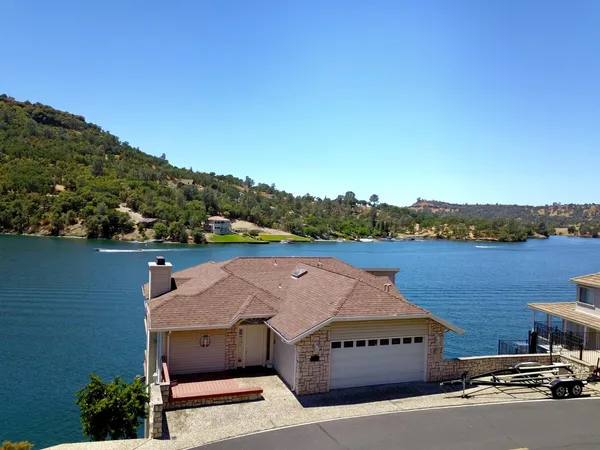 a side view of a house with a wooden deck