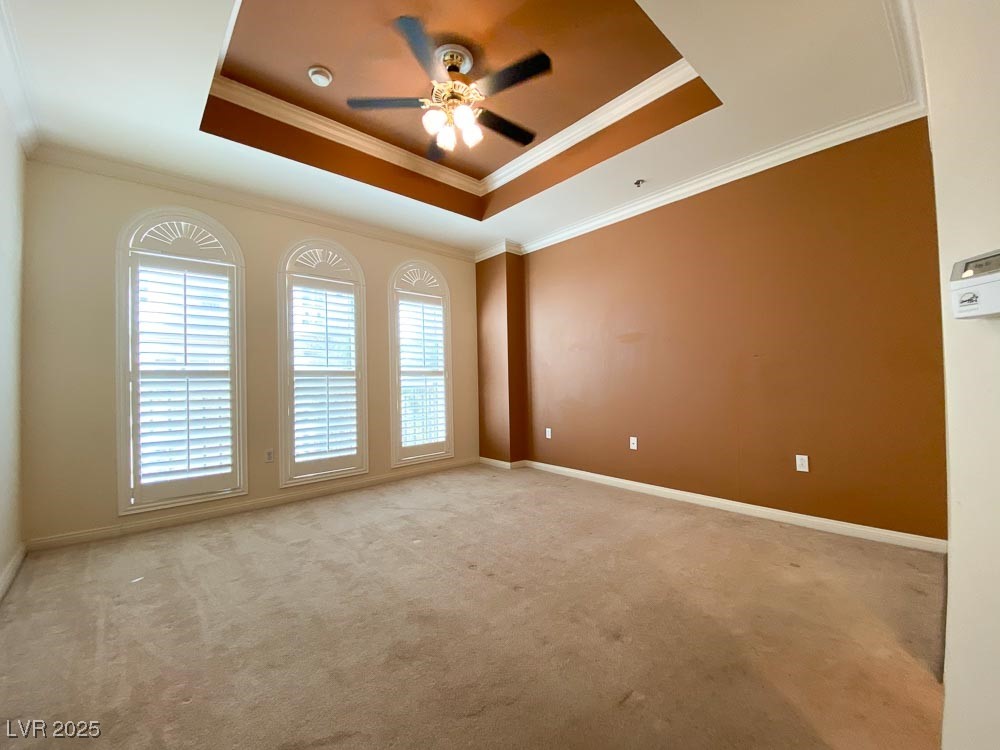 2405 East Serene Avenue, Unit 241 Las Vegas, NV 89123 - Photo 12 of 17 Empty room featuring a tray ceiling, a ceiling fan