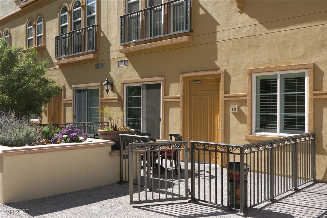 2405 East Serene Avenue, Unit 241 Las Vegas, NV 89123 - Photo 5 of 17 Gated entry to property, featuring stucco siding