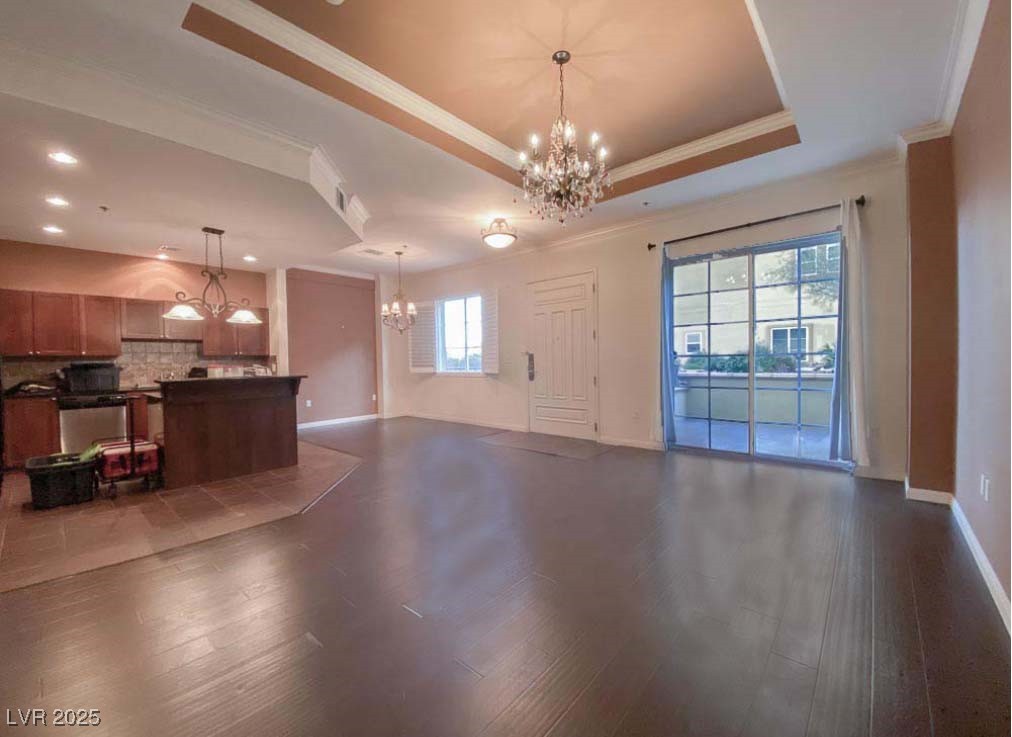 2405 East Serene Avenue, Unit 241 Las Vegas, NV 89123 - Photo 6 of 17 Unfurnished living room featuring a chandelier, cr