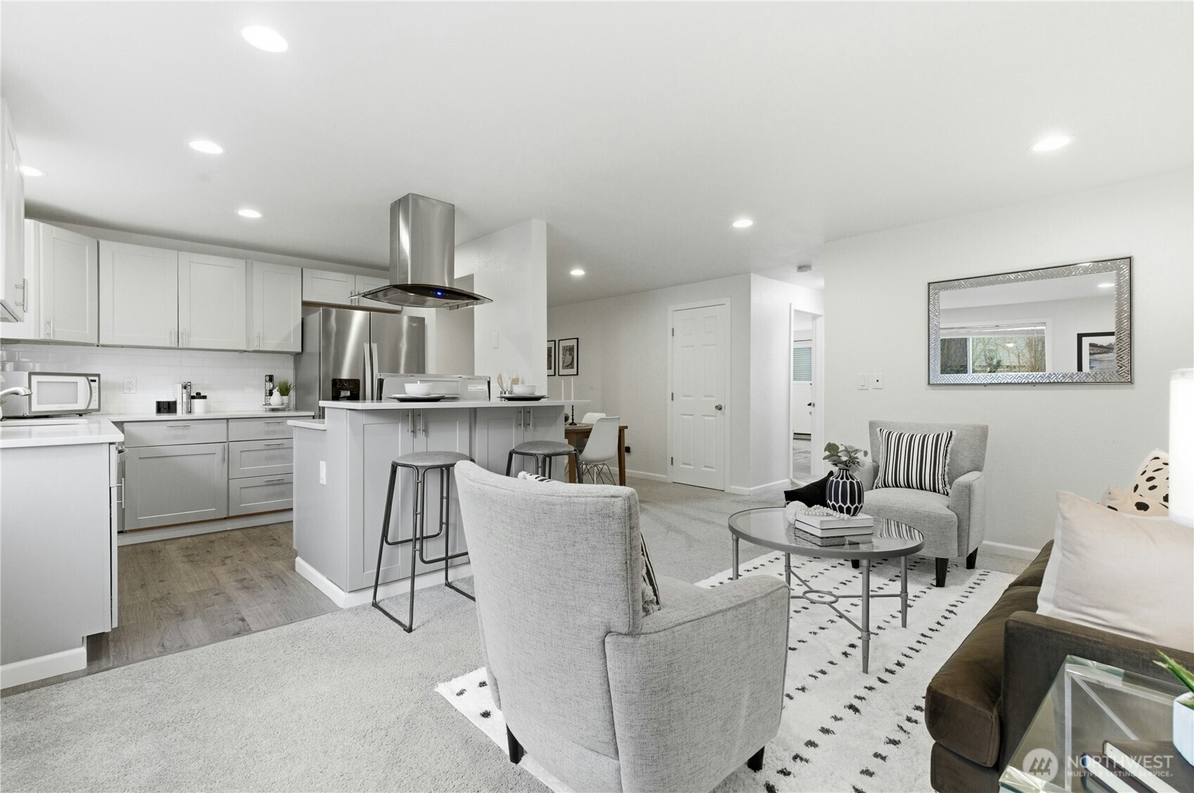 a living room with furniture and kitchen view