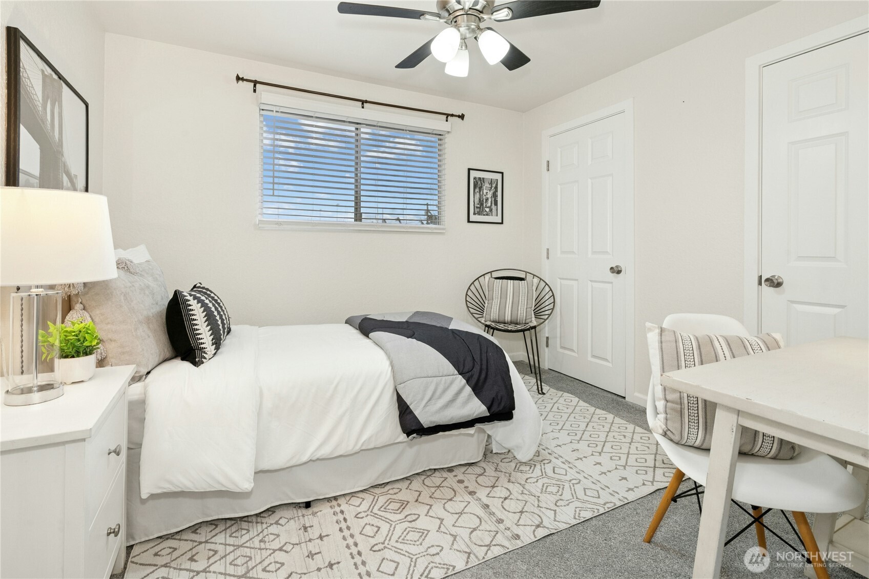 7909 218th Street Southwest, Unit 6 Edmonds, WA 98026 - Photo 15 of 27 a bedroom with a bed and a table in it
