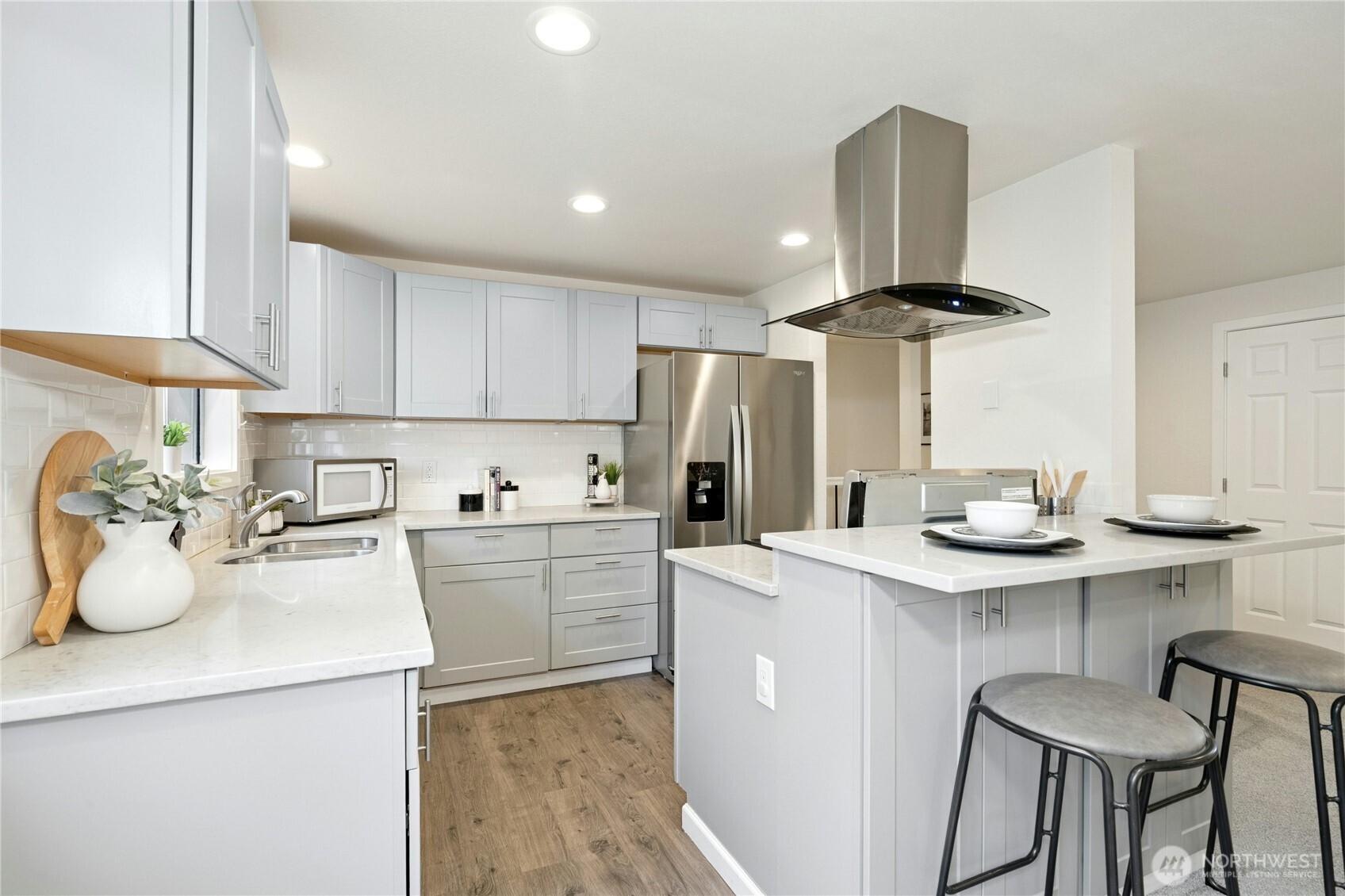 7909 218th Street Southwest, Unit 6 Edmonds, WA 98026 - Photo 4 of 27 a kitchen with a sink a stove and cabinets