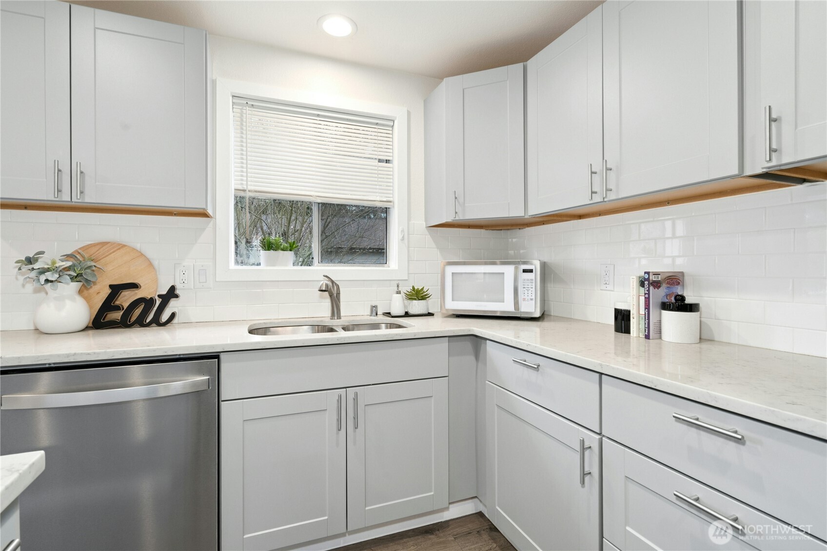 7909 218th Street Southwest, Unit 6 Edmonds, WA 98026 - Photo 5 of 27 a kitchen with a sink dishwasher window and cabinets