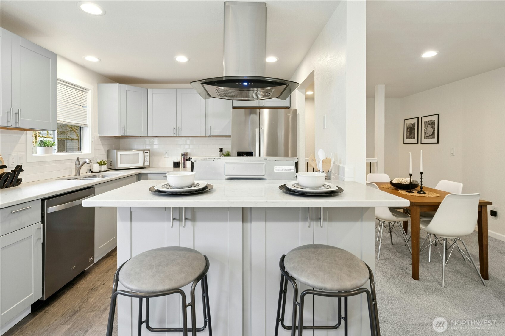 7909 218th Street Southwest, Unit 6 Edmonds, WA 98026 - Photo 6 of 27 a kitchen with granite countertop a table chairs stove and cabinets