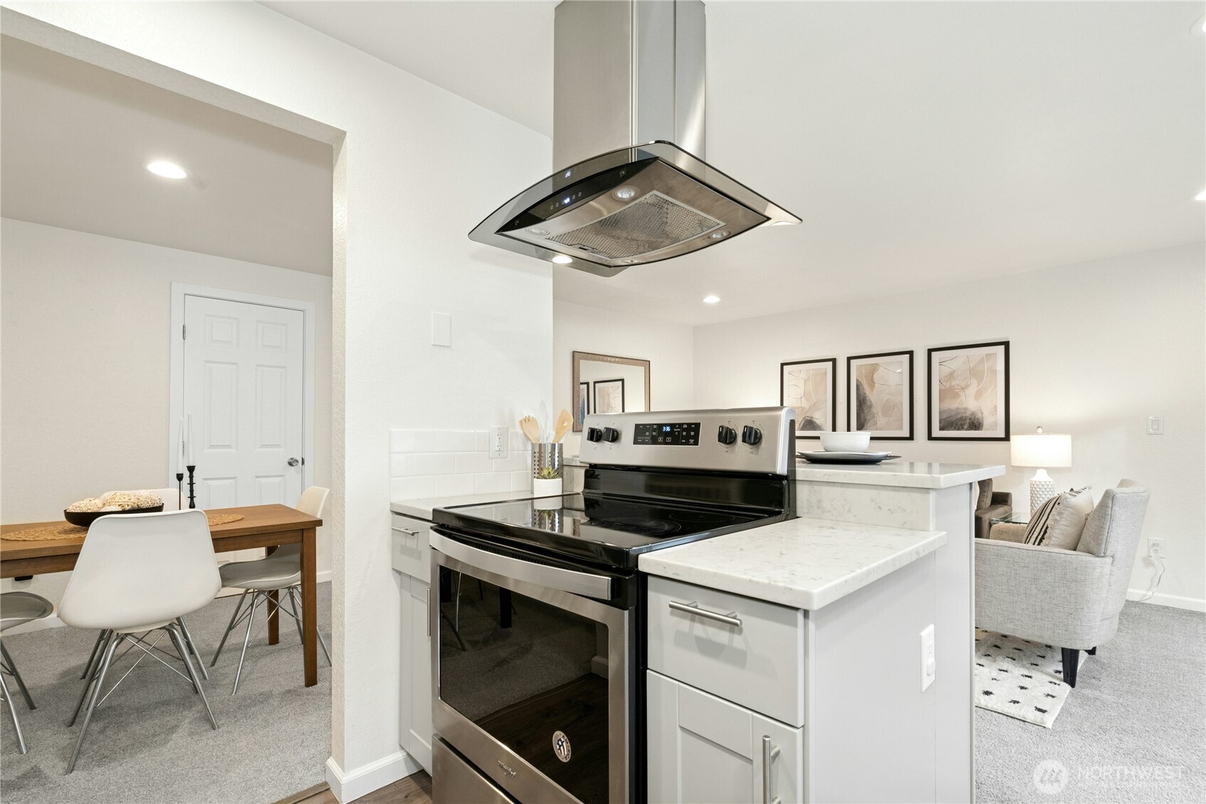 7909 218th Street Southwest, Unit 6 Edmonds, WA 98026 - Photo 9 of 27 a kitchen with a stove cabinets and chairs