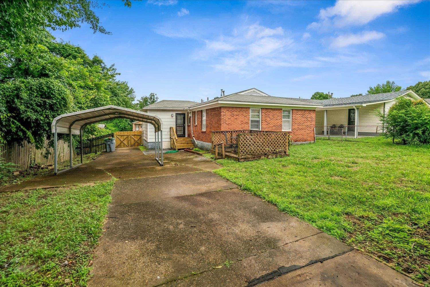 2518 Manchester Road Memphis, TN 38114 - Photo 22 of 23 Rear exterior featuring a carport, concrete driveway, and brick and siding facade