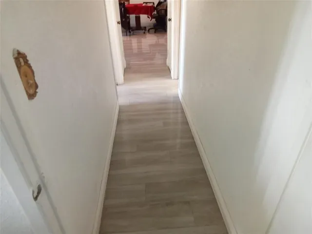 a view of entryway and hall with wooden floor