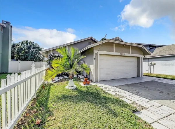 a view of a house with wooden fence