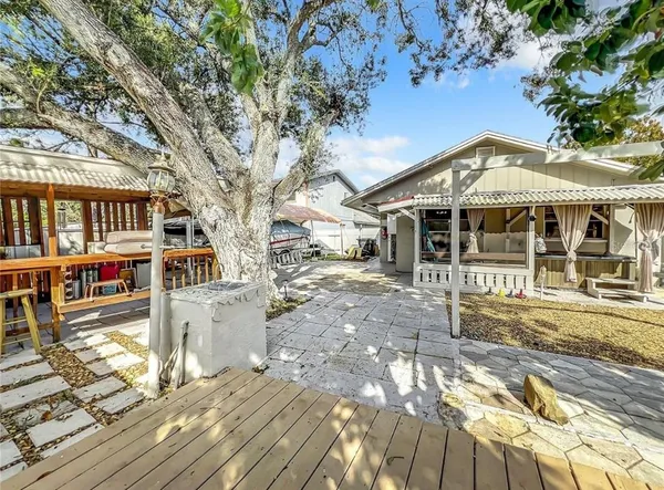 a front view of a house with a tree