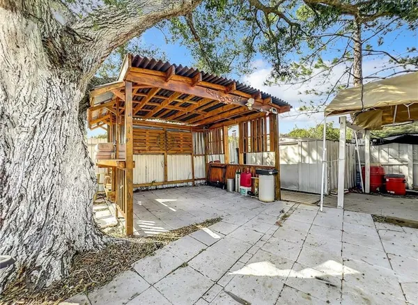 a kitchen with stainless steel appliances a refrigerator stove and wooden floor