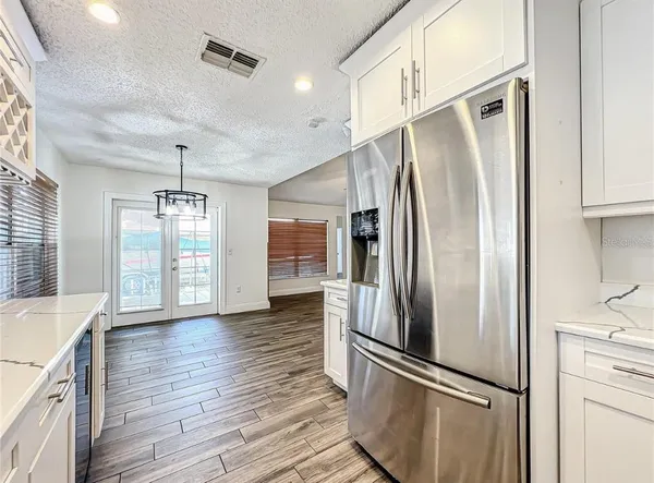 a kitchen with a sink cabinets stainless steel appliances and a counter space