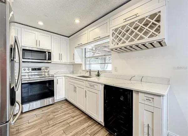 a kitchen with a sink cabinets and window