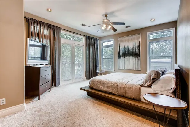 a bedroom with a bed and balcony view