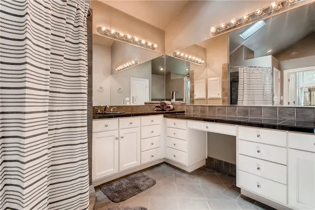 a spacious bathroom with a double vanity sink and a mirror